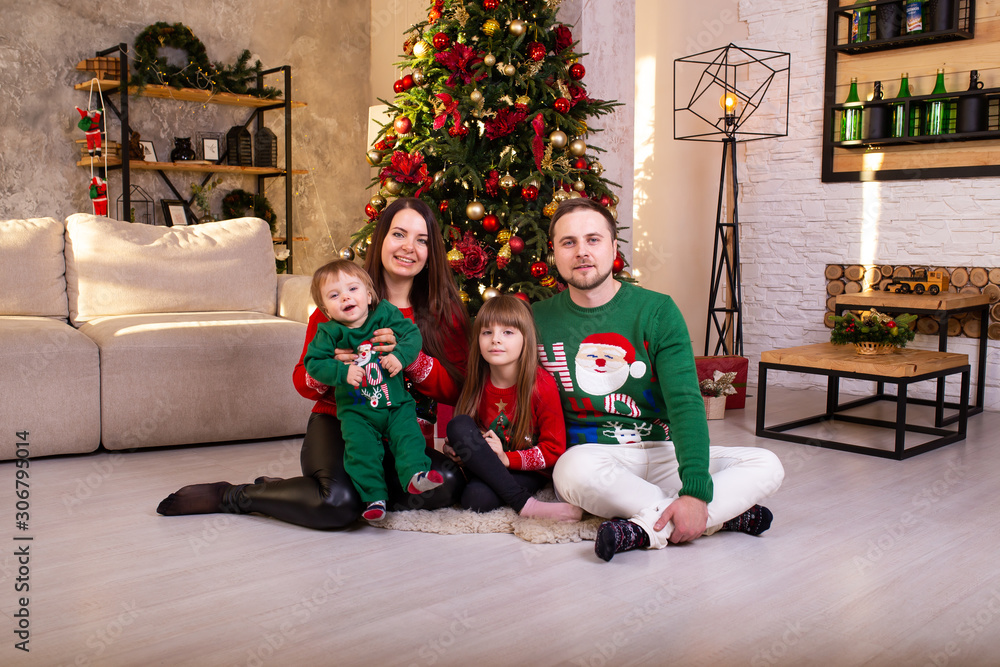 Happy family having fun together at home near Christmas tree at
