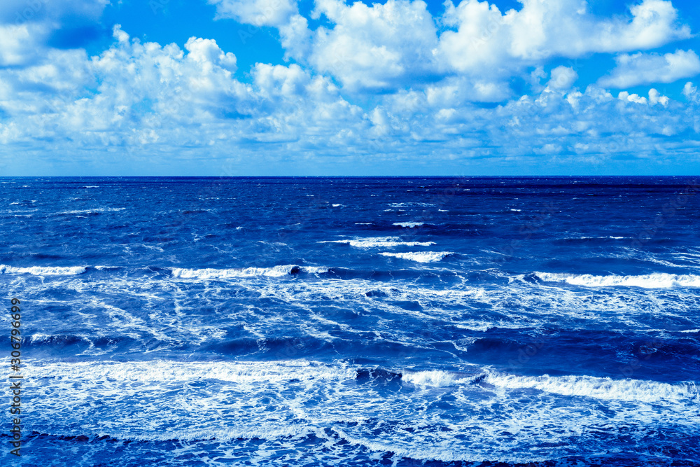 Summer seascape with clouds and waves.