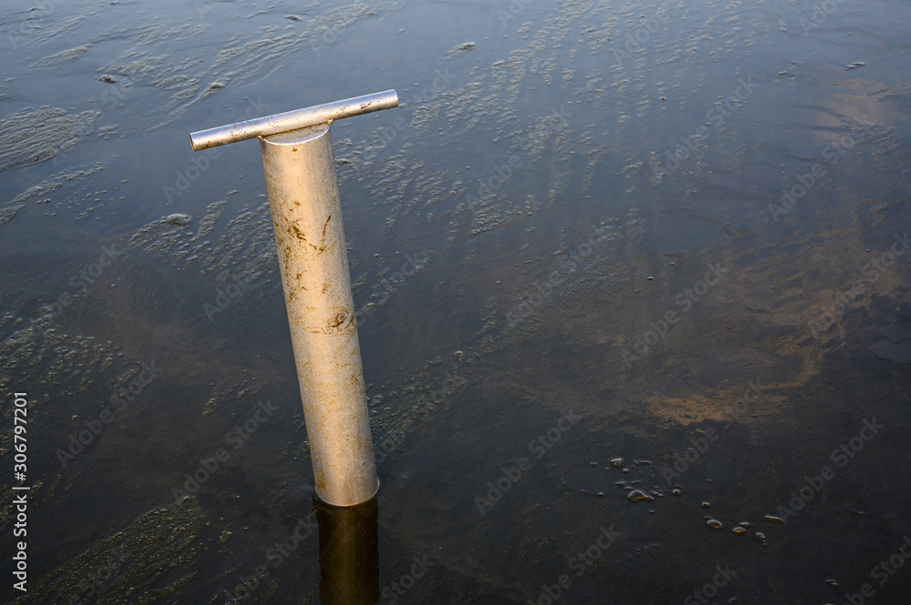 Clam gun, tool for digging razor clams, wet beach at Ocean Shores,  Washington State, USA Stock Photo