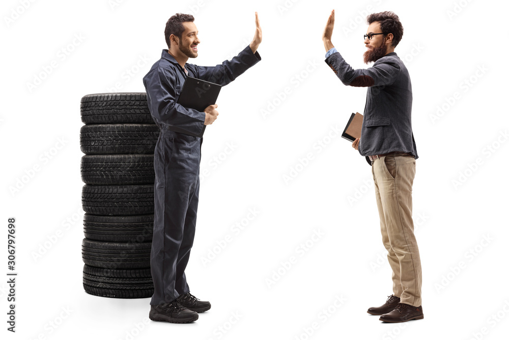 Auto mechanic gesturing high-fve with a bearded man