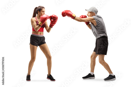 Senior man and a young woman training box