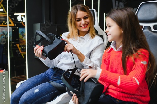 family, technology and virtual reality concept - mother and daughter in vr glasses