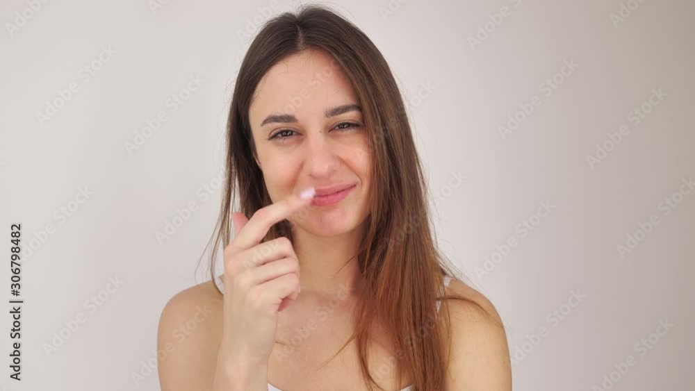 Sexy girl looking in camera on white background. Young woman touching lips with finger 4k Sexy girl looking in camera on white background. Young woman touching lips with finger 4k
