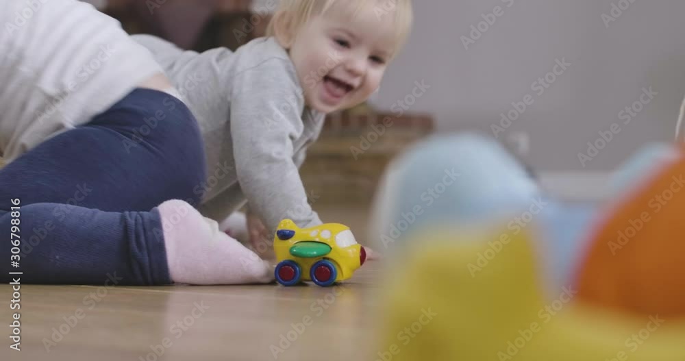 Cute Caucasian baby girl and her little sister crawling on the floor at home. Happy sisters having fun indoors. Leisure, resting, childhood, lifestyle. Cinema 4k ProRes HQ. Cute Caucasian baby girl and her little sister crawling on the floor at home. Happy sisters having fun indoors. Leisure, resting, childhood, lifestyle. Cinema 4k ProRes HQ.