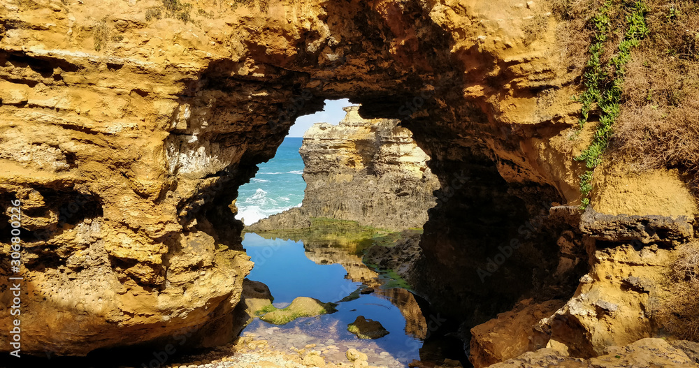 Cliff and shore viewed through a rock arch