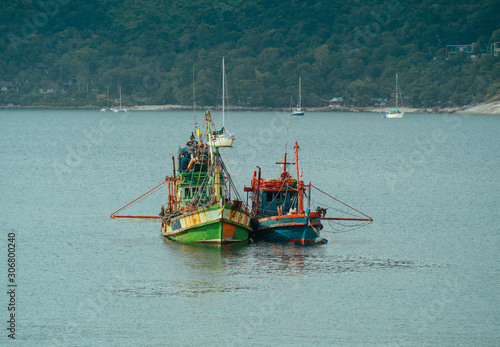 Fishing boat Engine on the beach in Asian tropical sea photo