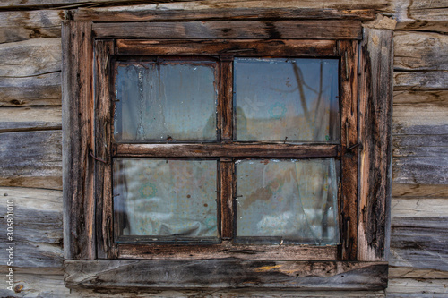 Russian village. Beautiful carved window with platbands in a Russian hut. Close-up.