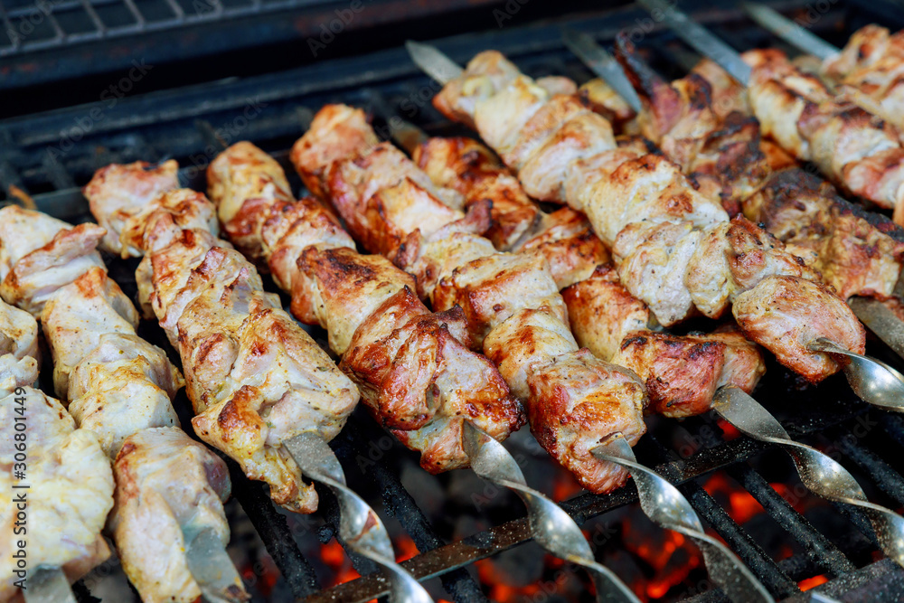 Meat on skewers is grilled with burning charcoal.