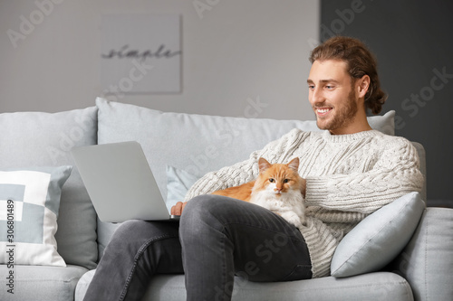 Man with laptop and his cut...