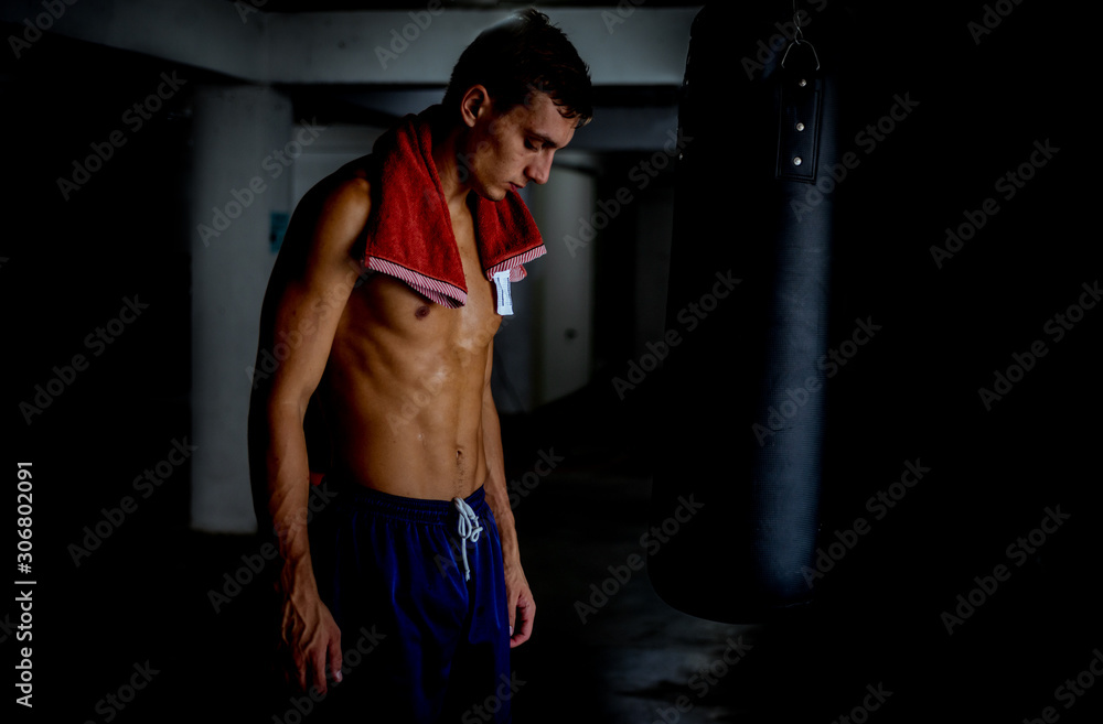 Sportive fighter resting from boxing training