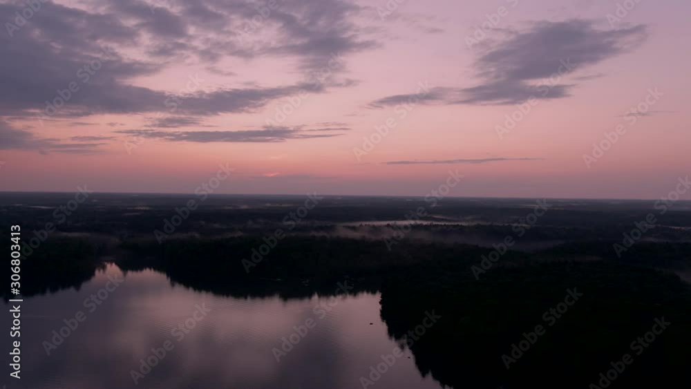 aerial post sunset tracking shot over a glass lake in Muskoka region aerial post sunset tracking shot over a glass lake in Muskoka region