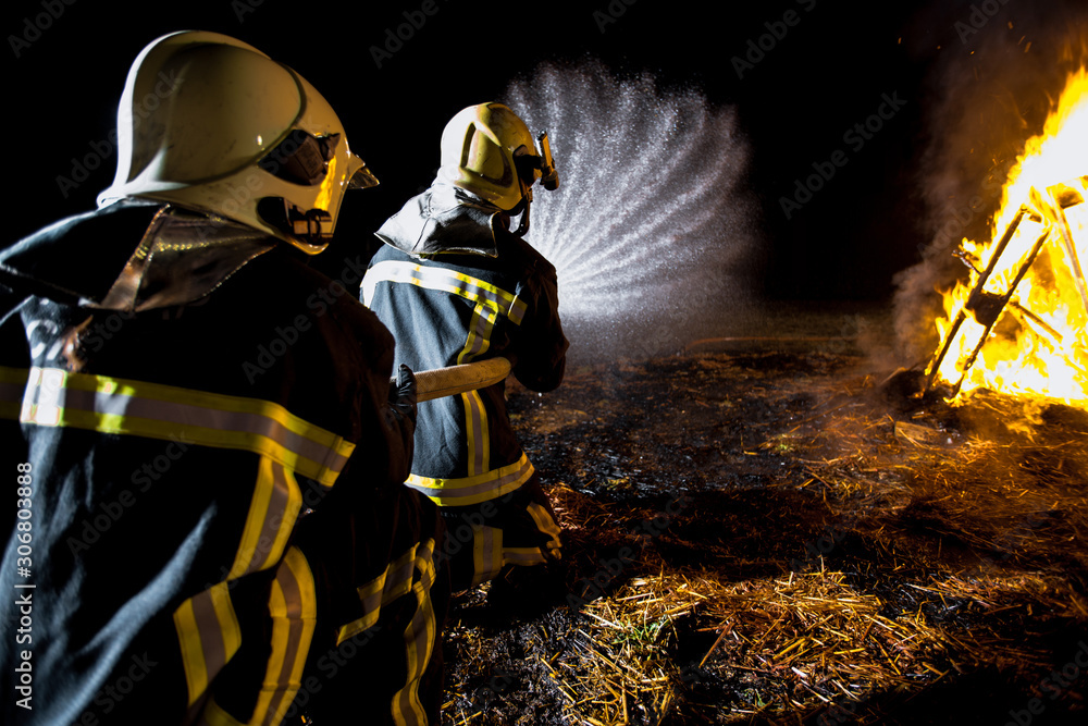 Naklejka premium Firefighting crew at a fire scene