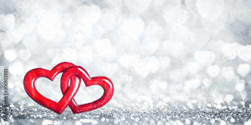 Two Wooden Interlocked Hearts With Silver Heart Bokeh Background - Valentine's Day/Marriage Concept