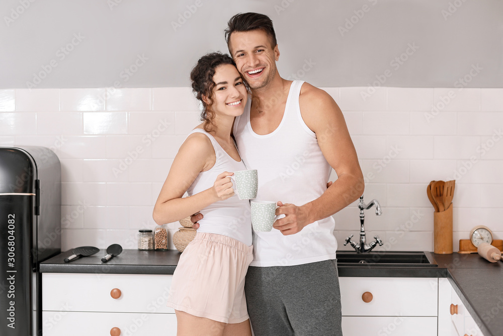 Happy young couple in kitchen at home Happy young couple in kitchen at home
