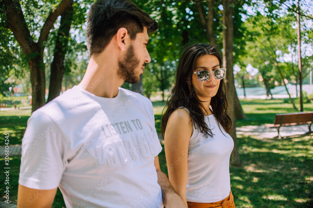 Amorous couple taking walk in natural environment Amorous couple taking walk in natural environment