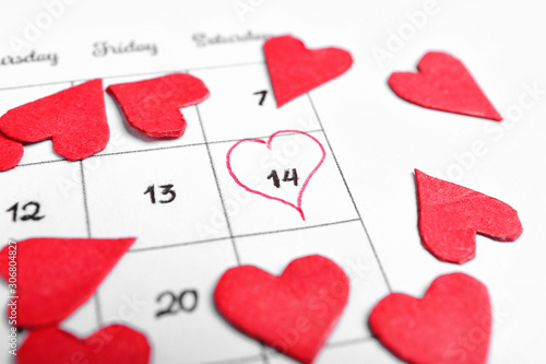 Red hearts on calendar with...