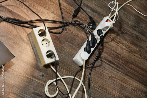 Fotografie Cables and extension blocks, electreic devices in a mess