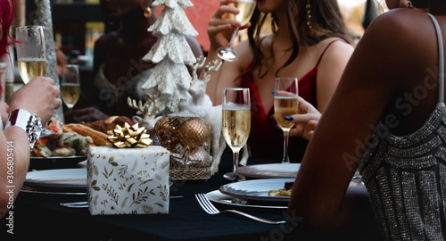 female woman champagne glass and gift box on the table fashion xmas Christmas party at restaurant dishes plats dinner Christmas decoration holiday