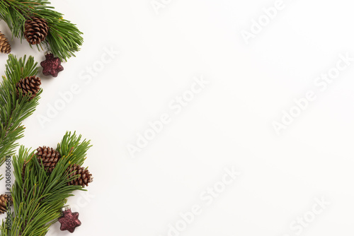 Christmas composition. Spruce branches with cones and christmas decorations, on a white background. Christmas, winter, new year concept. Flat lay, top view, copy space.