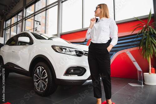 business woman in auto salon. concept of female driver © Serhii