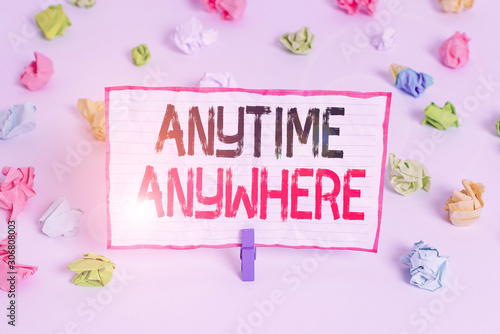 Handwriting text writing Anytime Anywhere. Conceptual photo saying that you can do something at every place and moment Colored crumpled papers empty reminder white floor background clothespin © Artur