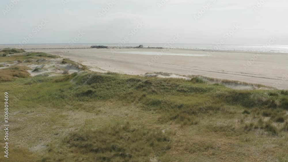 Cinematic drone / aerial shot of the green and sandy nature beach of St. Peter Ording at the north sea, schleswig holstein, germany, 30p Cinematic drone / aerial shot of the green and sandy nature beach of St. Peter Ording at the north sea, schleswig holstein, germany, 30p