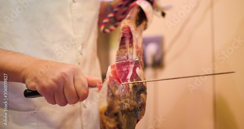 slicing Jamon, Pata Negra in a market, Mercado, Spanish Ham