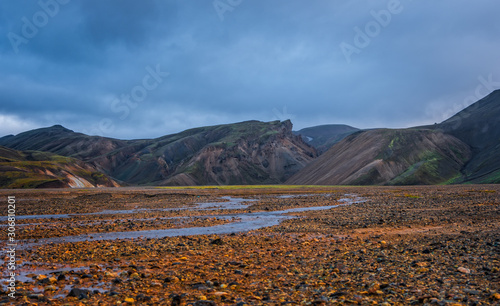 Iceland in september 2019. Great Valley Park Landmannalaugar, surrounded by mountains of rhyolite and unmelted snow. In the valley built large camp. Evening in september 2019 photo