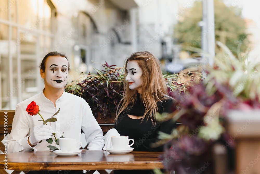 Male mime giving a flower to female mime Male mime giving a flower to female mime