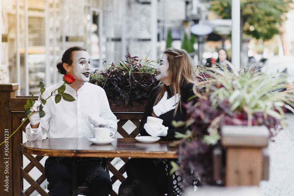 Male mime giving a flower to female mime Male mime giving a flower to female mime