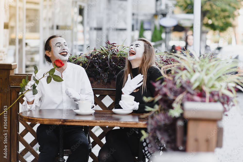 Mimes in front of Paris cafe acting like drinking tea or coffee. Mimes in front of Paris cafe acting like drinking tea or coffee.