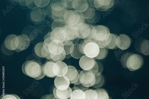 the concept of boating, relaxing at sea - splashes of blue water in the sea close-up. Colorful Bright Stage Lights in a Concert the blurred blue and white light spotlights. boce as background