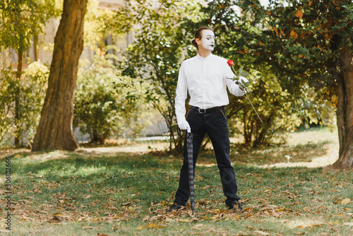 young Funny mime shows something.