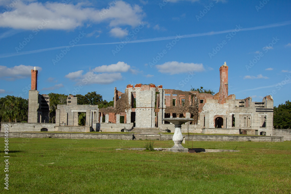 Mansion Ruins with Stone Fountain Against Blue Sky