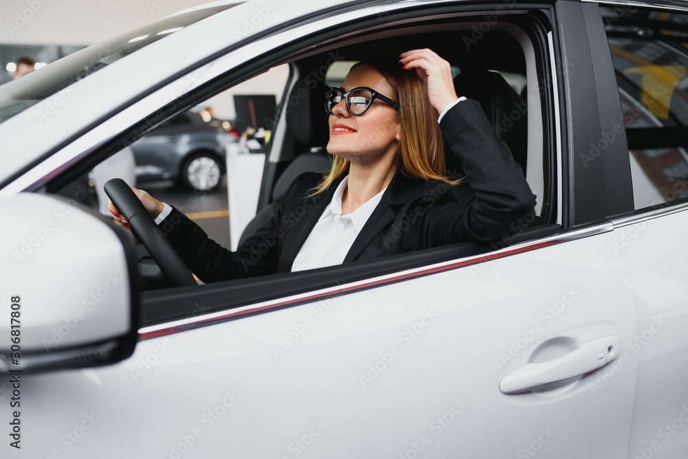 Young business woman driving in her car to work. Successful business concept. business woman driving Young business woman driving in her car to work. Successful business concept. business woman driving