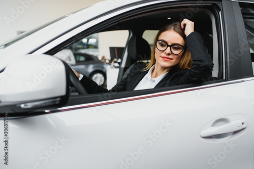 Young business woman driving in her car to work. Successful business concept. business woman driving © Serhii
