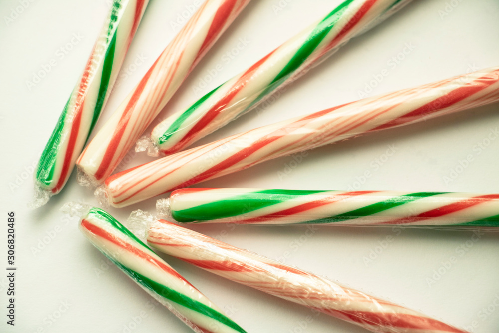 Isolated Candy Cane Close Up Colorful candy used for decorating Christmas trees and gingerbread houses. Holiday treat. Macro view. White background. Fun and sweet. Isolated Candy Cane Close Up Colorful candy used for decorating Christmas trees and gingerbread houses. Holiday treat. Macro view. White background. Fun and sweet.