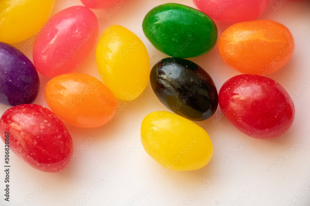 Isolated Jelly Bean Close Up Colorful candy used for decorating cookies, treats and gingerbread houses. Easter treat. Macro view. White background. Fun and sweet. Isolated Jelly Bean Close Up Colorful candy used for decorating cookies, treats and gingerbread houses. Easter treat. Macro view. White background. Fun and sweet.