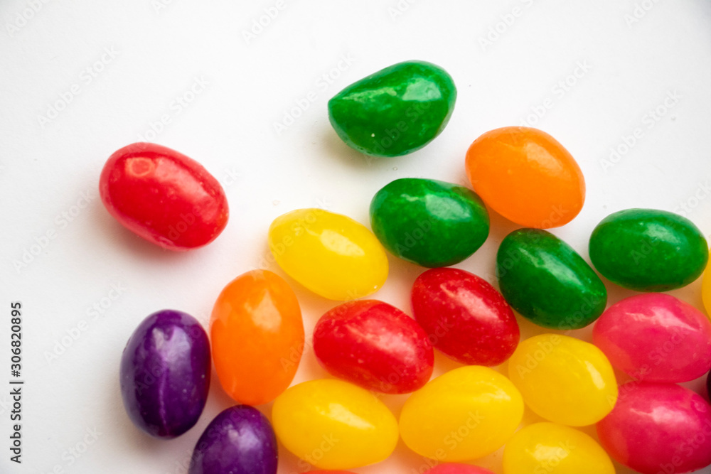 Isolated Jelly Bean Close Up Colorful candy used for decorating cookies, treats and gingerbread houses. Easter treat. Macro view. White background. Fun and sweet. Isolated Jelly Bean Close Up Colorful candy used for decorating cookies, treats and gingerbread houses. Easter treat. Macro view. White background. Fun and sweet.