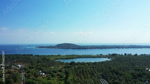 Wallpaper Mural Large tropical Gili islands with palm trees forest, village's houses and resorts for tourists surrounded by blue sea under clear bright sky Torontodigital.ca