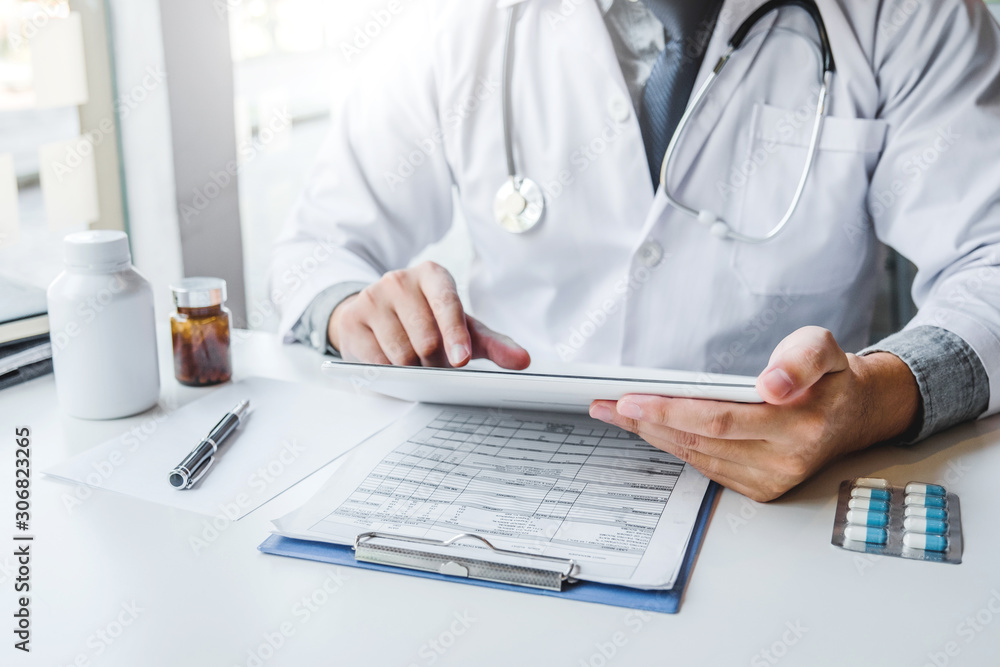 Doctor working in Hospital office and thinking about Disease problem of patient Doctor working in Hospital office and thinking about Disease problem of patient