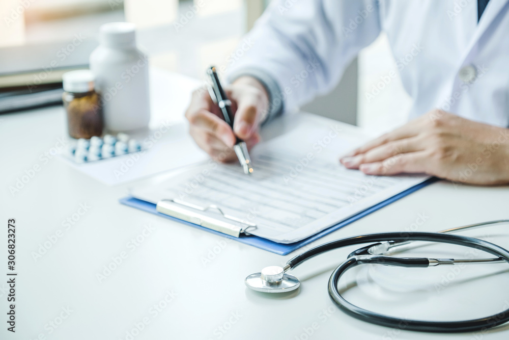 Doctor working in Hospital office and thinking about Disease problem of patient Doctor working in Hospital office and thinking about Disease problem of patient