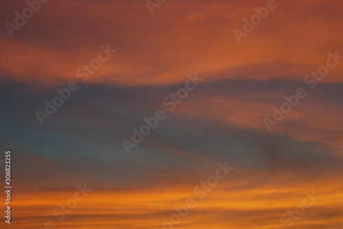 Fototapeta Naklejka Na Ścianę i Meble -  Blue sky hole that surrounding by glowing orange cloud in an evening