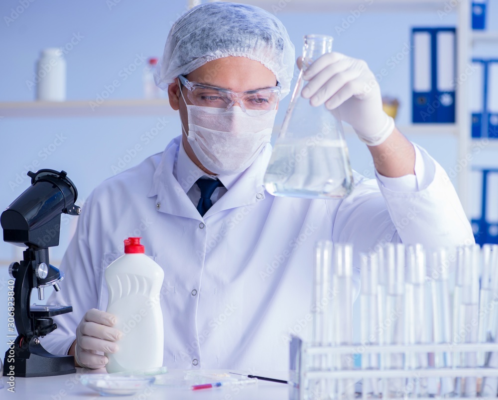Man in the lab testing new cleaning solution detergent Man in the lab testing new cleaning solution detergent
