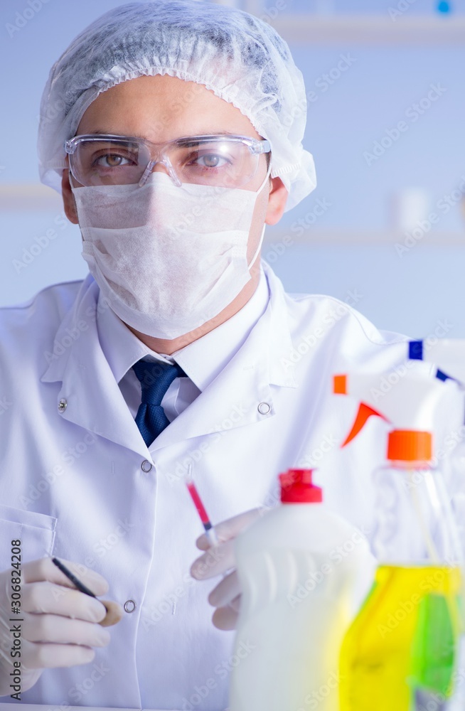 Man in the lab testing new cleaning solution detergent Man in the lab testing new cleaning solution detergent