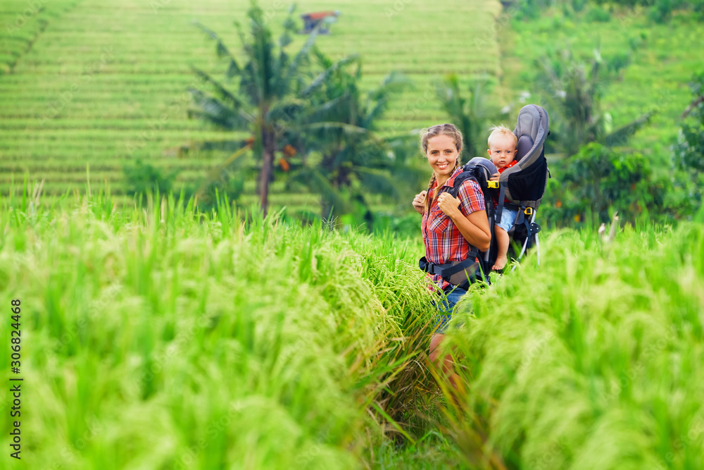 Nature walk in green rice terrace field. Happy mother hold little ...