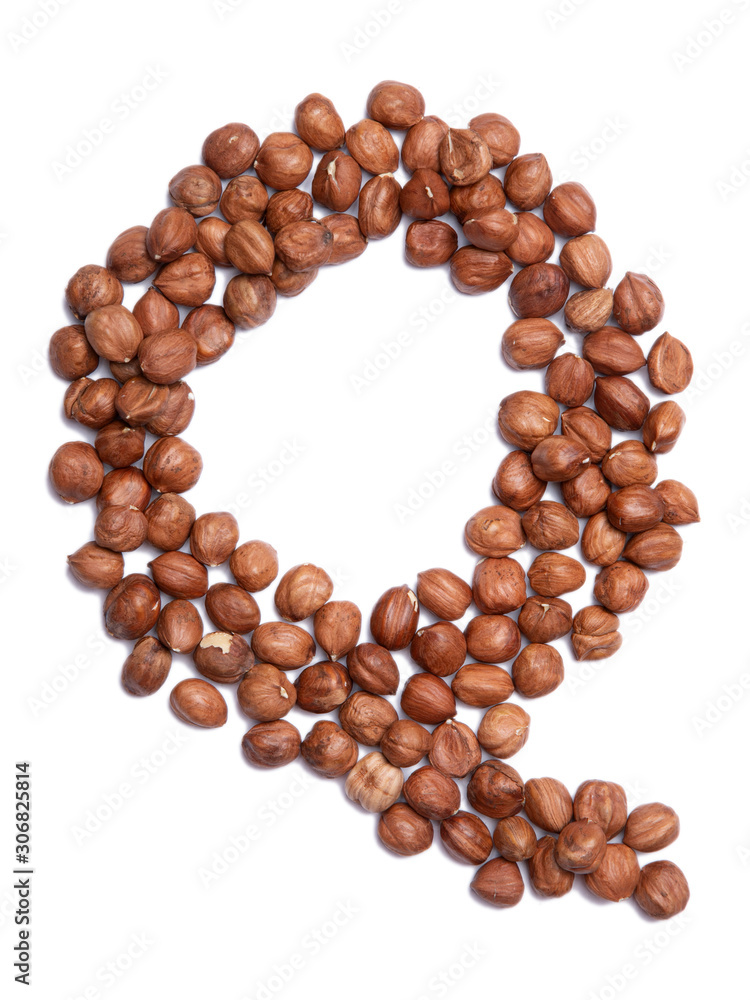 Letter Q of the English alphabet from from hazelnut on a white isolated background. Food pattern made from nuts. Bright alphabet for shops. Letter Q of the English alphabet from from hazelnut on a white isolated background. Food pattern made from nuts. Bright alphabet for shops.