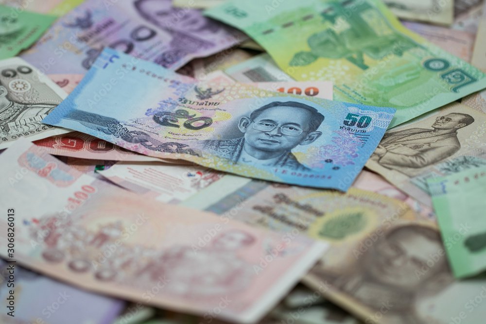 Fototapeta premium Thai money - Baht.Thai money - Baht.Pile of various currencies isolated on white background.Thai baht banknote coin isolated on white background.Many of Thai Baht background.Thai currency.