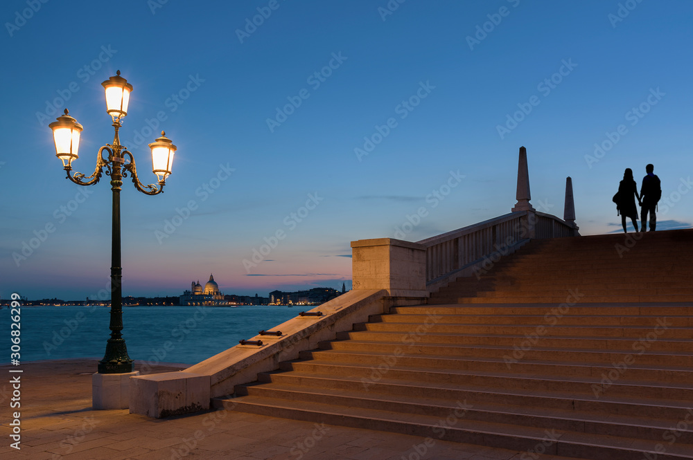 Silhouette of love couple in Venice at dusk