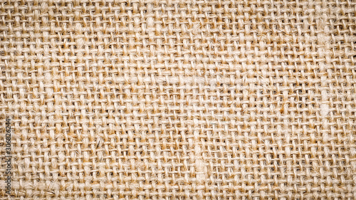 Cotton woven fabric background with flecks of varying colors of beige and brown. with copy space. office desk concept, Jute hessian sackcloth natura / Hessian sackcloth burlap woven texture background
